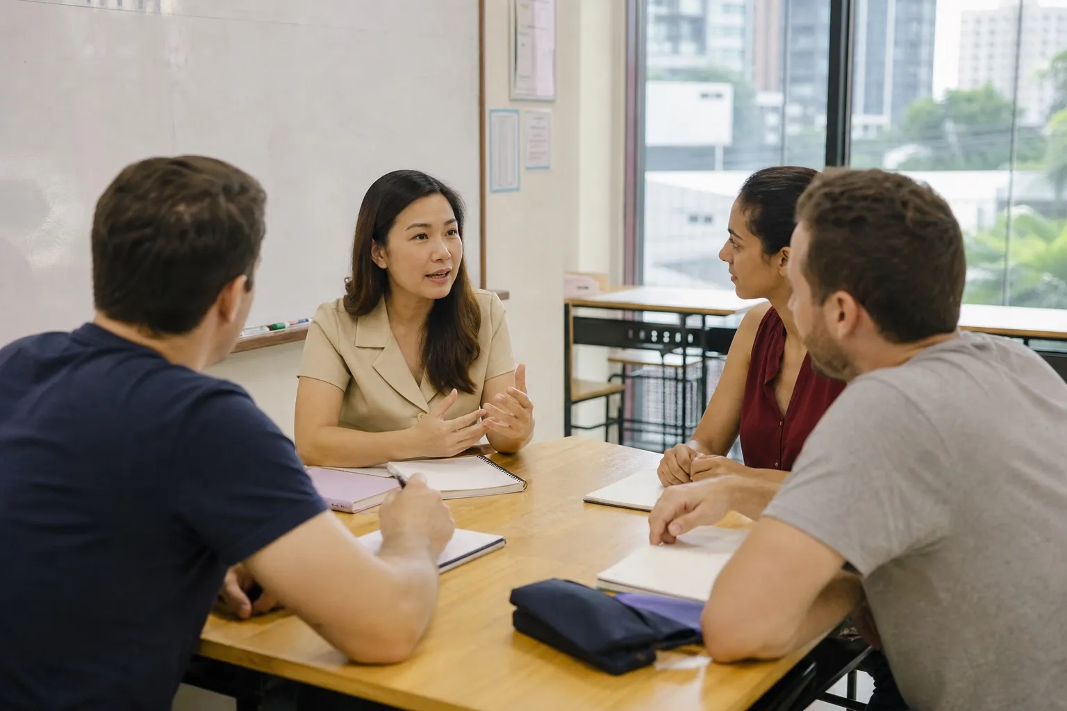 Adult learners practising short Thai answers with a teacher