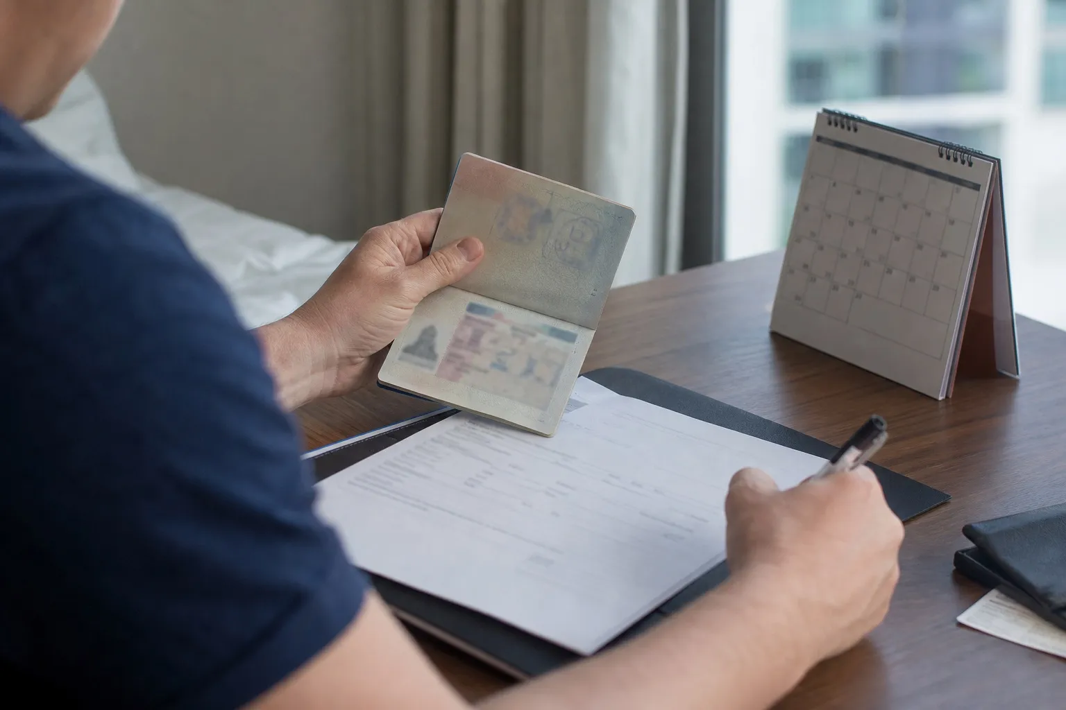 Traveller checking a passport and calendar before applying for a Thailand visa extension